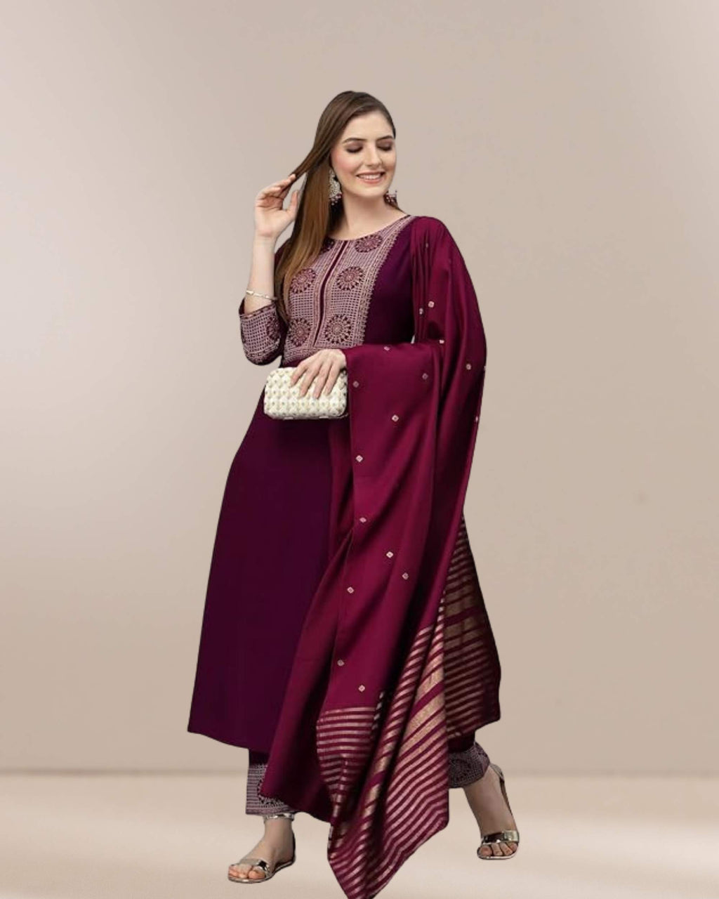 Woman wearing a maroon traditional outfit with a beige background
