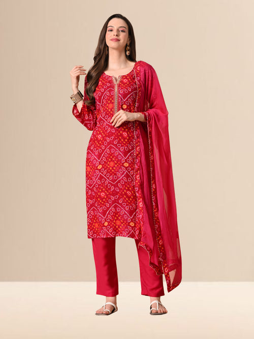 Woman wearing a red Bandhani print cotton kurta set with trousers and a chiffon dupatta, featuring Gota-patti work on the neck, ideal for festive and daily wear.