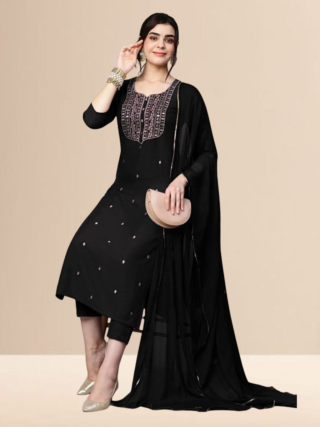 Woman wearing a black embroidered georgette kurta set with trousers and a dupatta, suitable for festive and daily wear. 