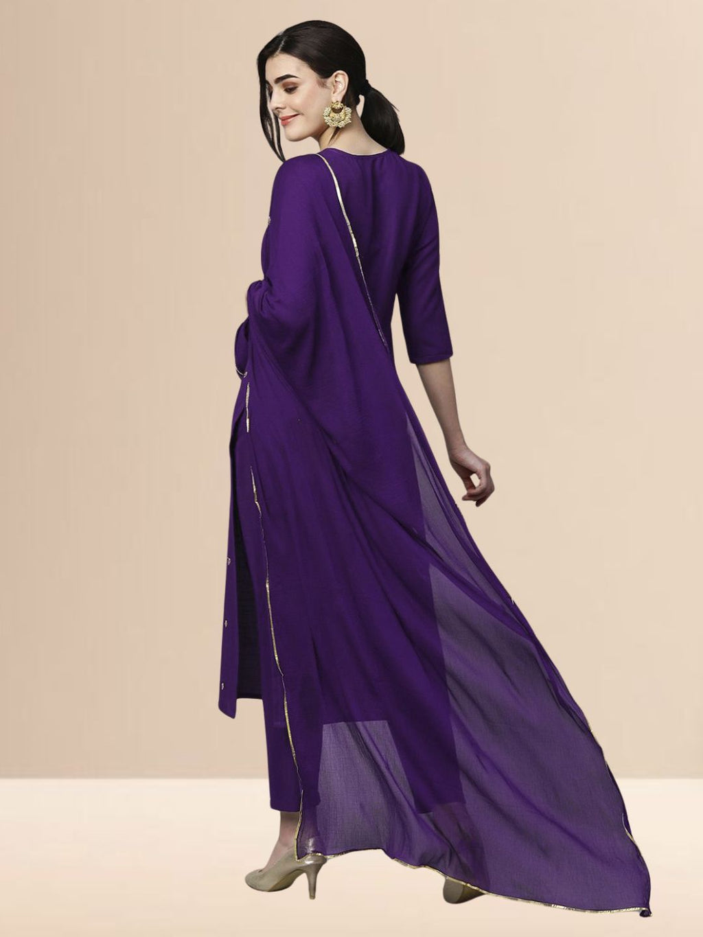 Woman wearing a royal purple embroidered rayon kurta set with trousers and a dupatta, ideal for festive and daily wear.