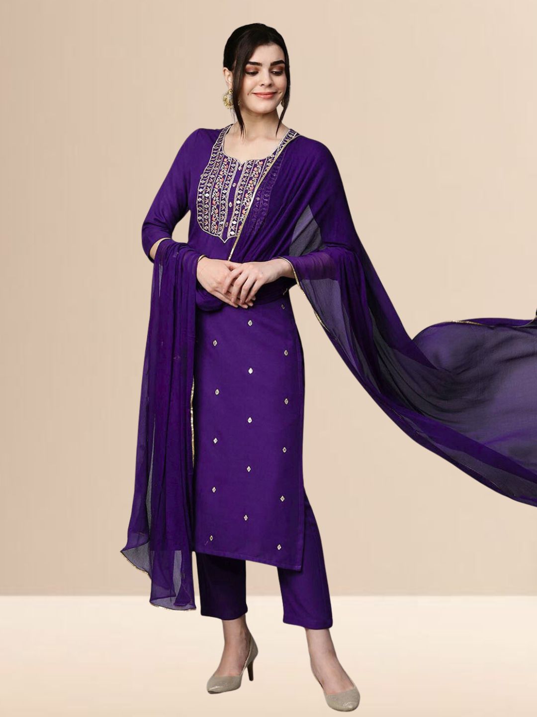 Woman wearing a royal purple embroidered rayon kurta set with trousers and a dupatta, ideal for festive and daily wear.