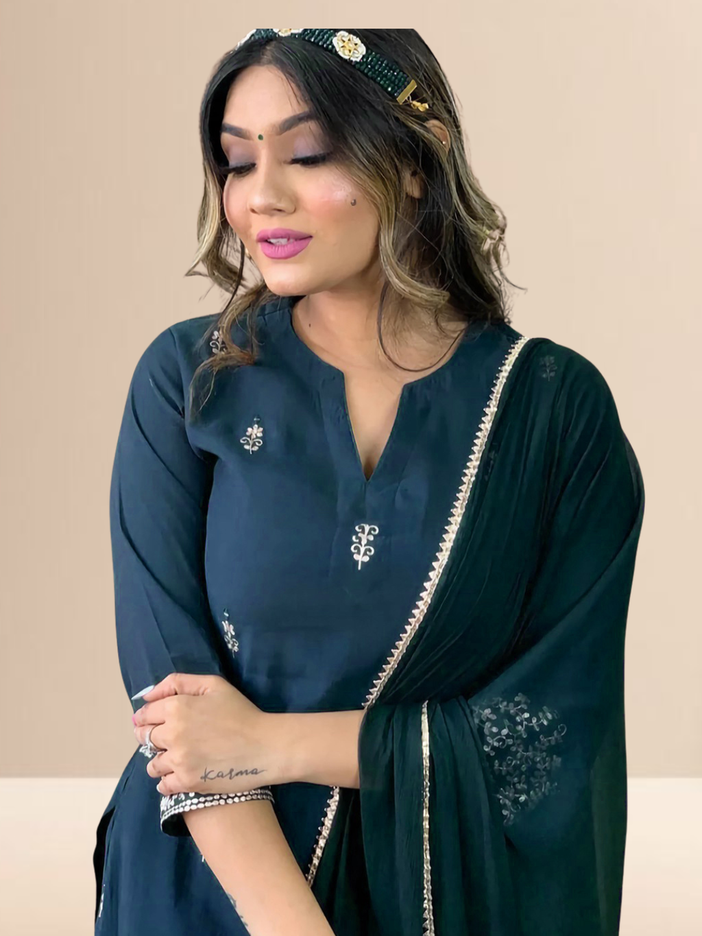 Woman wearing a deep teal embroidered silk blend kurta set with matching pants and a dupatta, suitable for festive and daily wear.