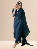 Woman wearing a deep teal embroidered silk blend kurta set with matching pants and a dupatta, suitable for festive and daily wear.