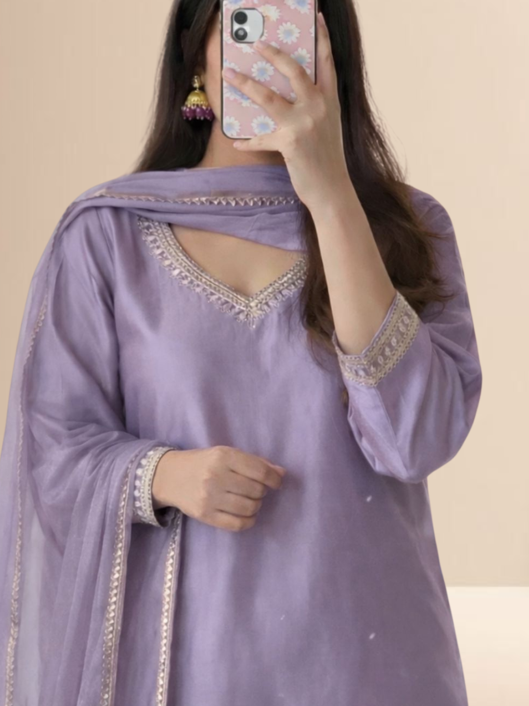 Woman wearing a lavender cotton blend kurta set with delicate lace work on the neck and sleeves, paired with a matching dupatta.