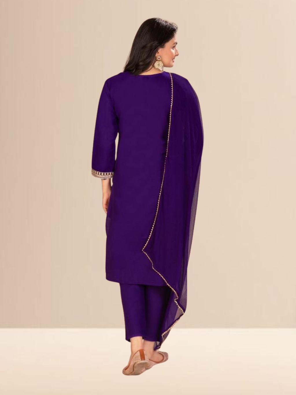 Woman wearing a royal purple kurta set with gold embroidery on the neck and sleeves, paired with trousers and a dupatta.