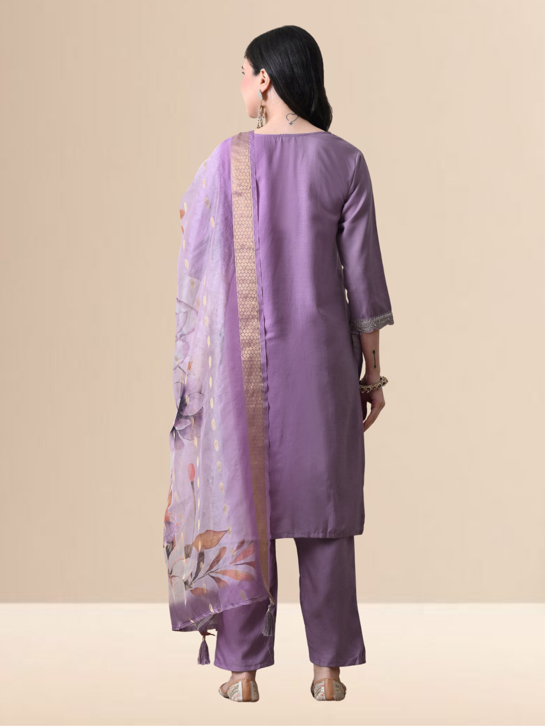 A woman wearing a mauve embroidered cotton blend kurta set with matching pants and a floral printed dupatta.