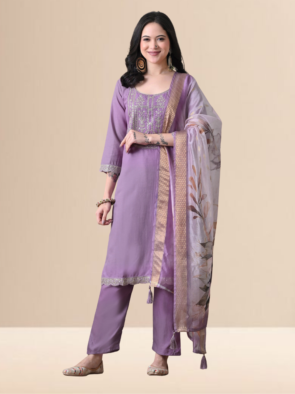 A woman wearing a mauve embroidered cotton blend kurta set with matching pants and a floral printed dupatta.