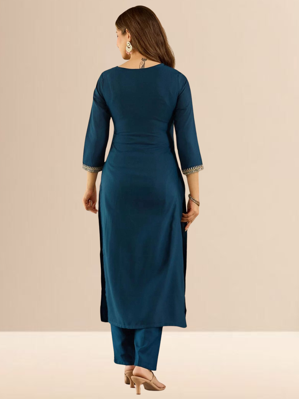 Woman wearing a teal blue cotton blend kurta set with intricate golden V-neck embroidery, matching pants, and a dupatta with gold lace borders.