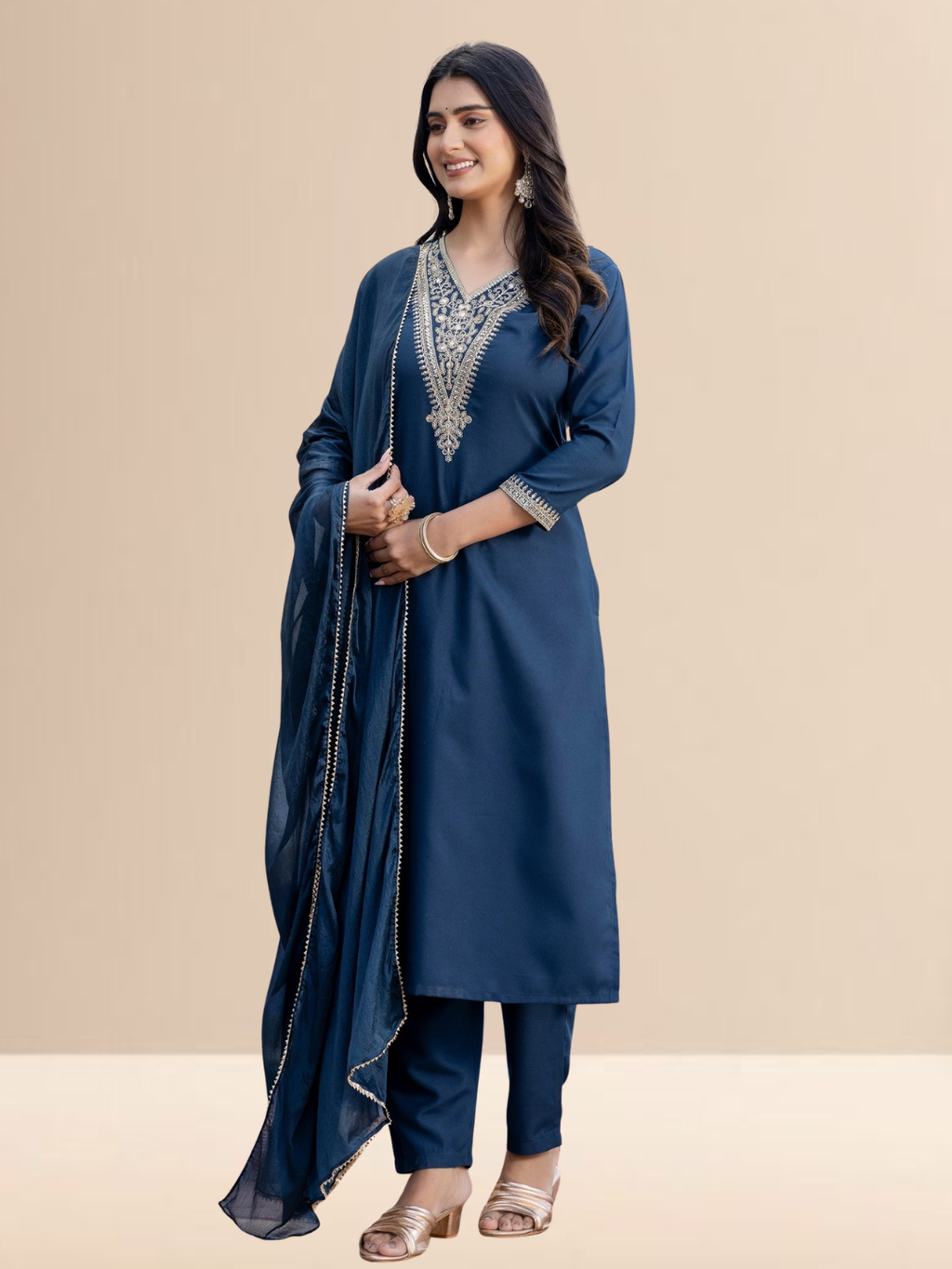 Woman wearing a teal blue cotton blend kurta set with intricate golden V-neck embroidery, matching pants, and a dupatta with gold lace borders.