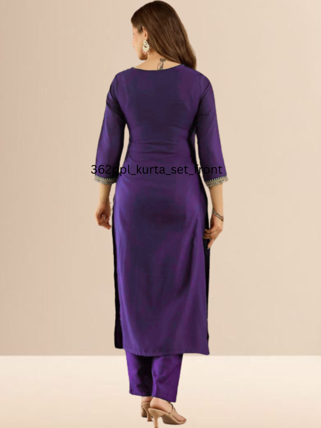 Woman wearing a purple traditional outfit with silver embroidery on a beige background