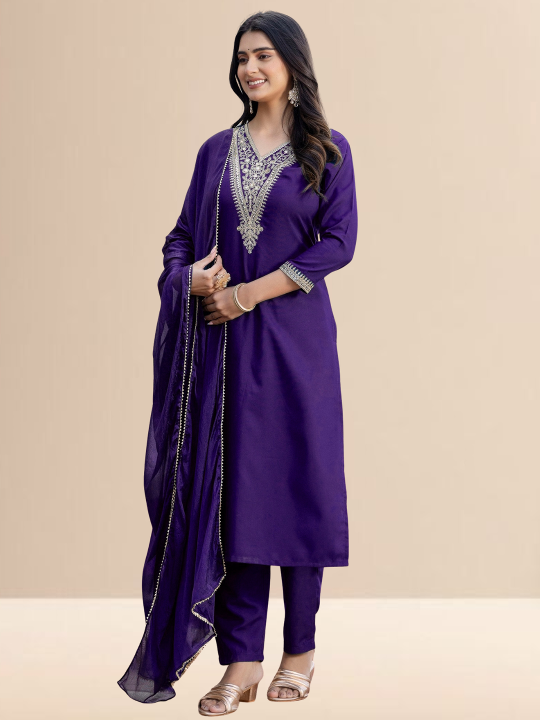 Woman wearing a purple traditional outfit with silver embroidery on a beige background