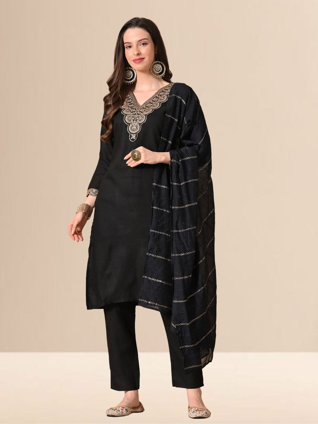 Woman wearing a black straight-cut cotton blend kurta with gold V-neck embroidery, matching trousers, and a black dupatta with gold stripes.