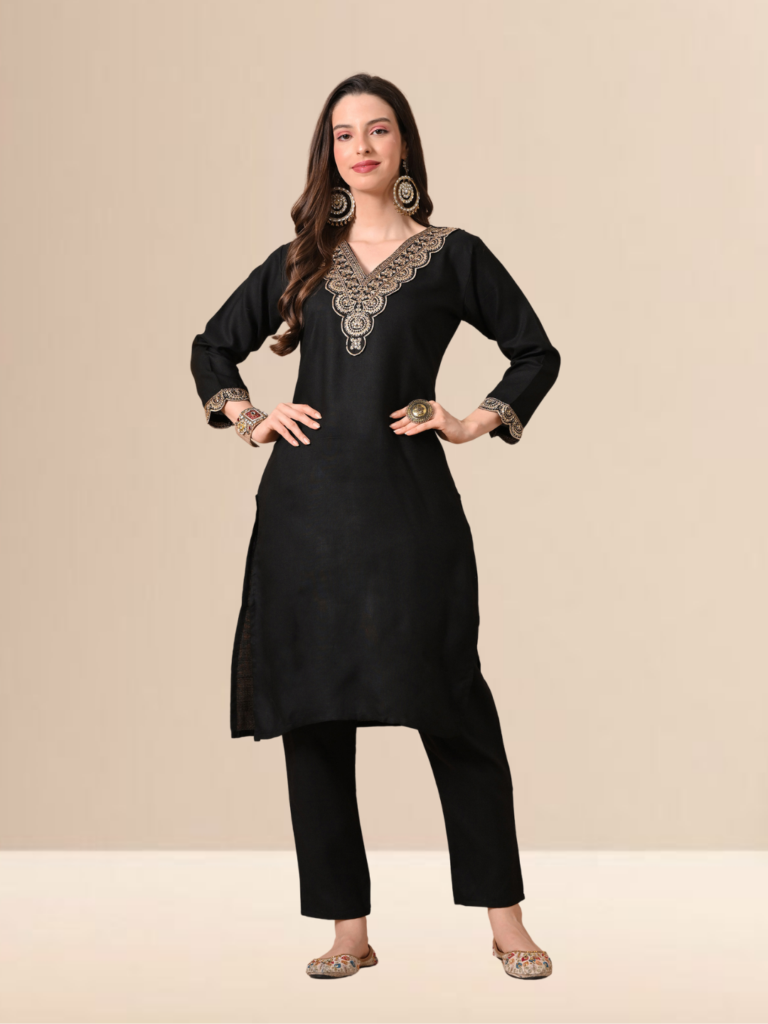 Woman wearing a black straight-cut cotton blend kurta with gold V-neck embroidery, matching trousers, and a black dupatta with gold stripes.