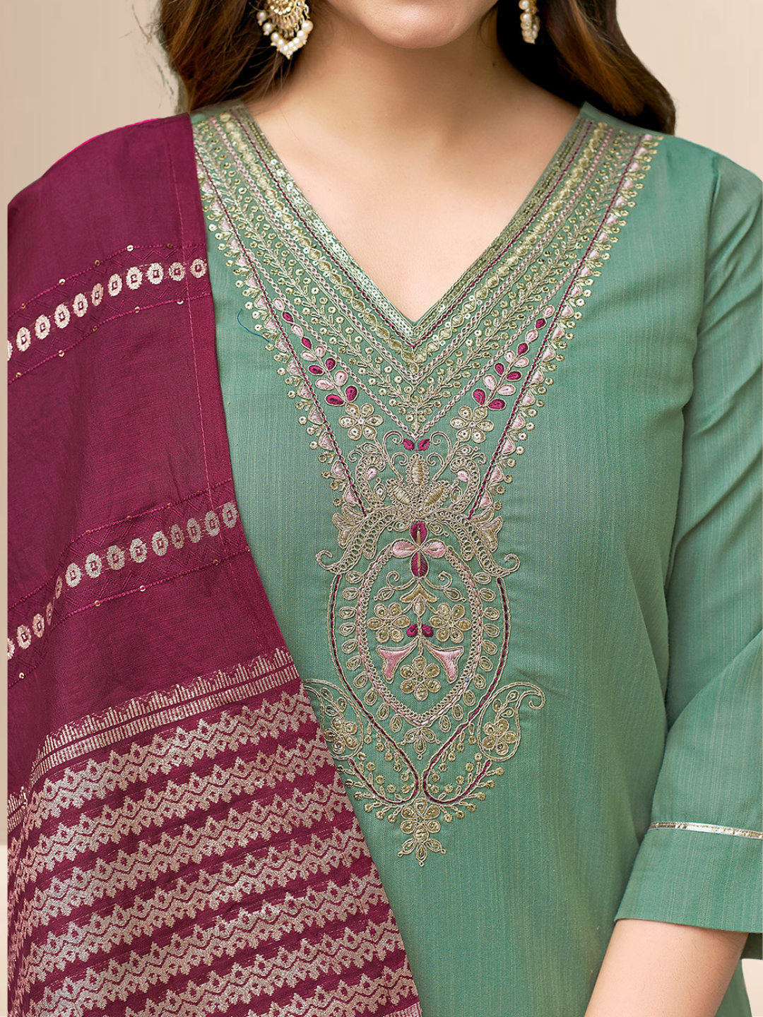 Woman wearing a sea green cotton blend kurta with an embroidered V-neck and a wine-colored striped dupatta.
