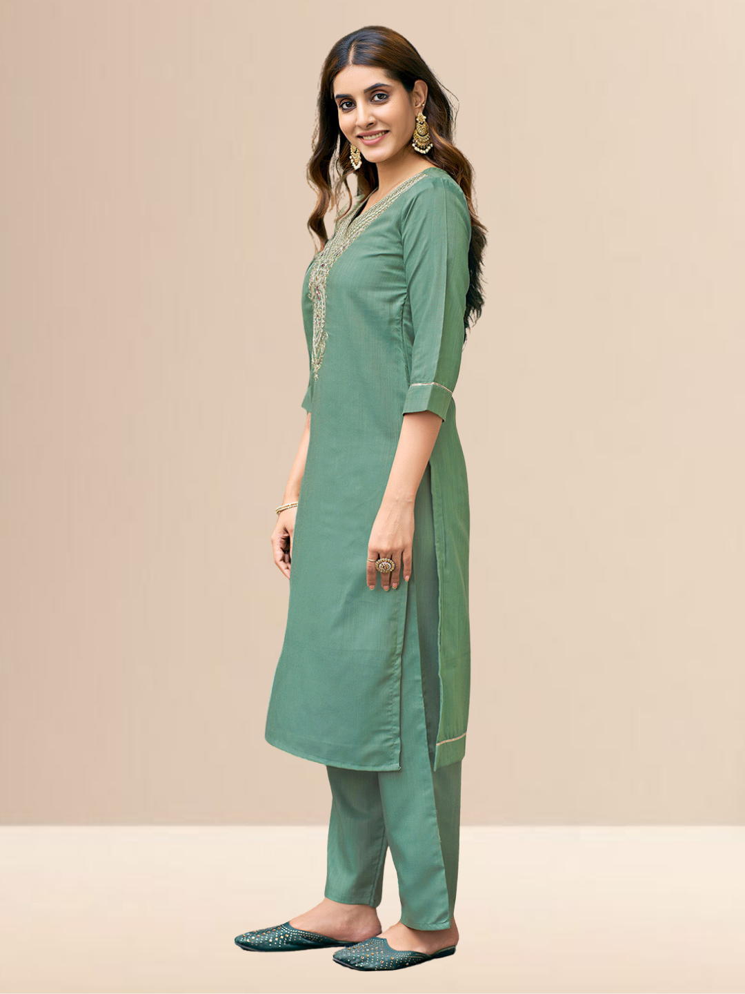 Woman wearing a sea green cotton blend kurta with an embroidered V-neck and a wine-colored striped dupatta.