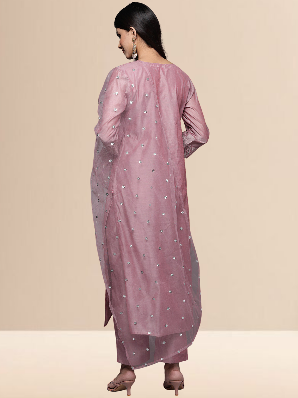 A woman in a mauve cotton-blend kurta set with white thread embroidery on the neck and a sheer sequined dupatta.