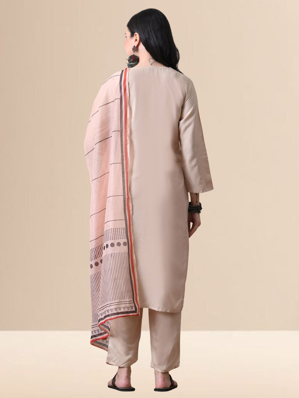 Woman wearing a beige chanderi kurta and pant set with a striped and dotted printed dupatta.