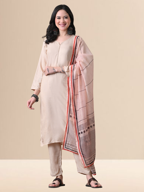 Woman wearing a beige chanderi kurta and pant set with a striped and dotted printed dupatta.
