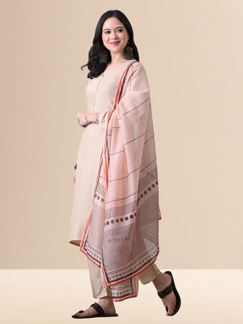 Woman wearing a beige chanderi kurta and pant set with a striped and dotted printed dupatta.