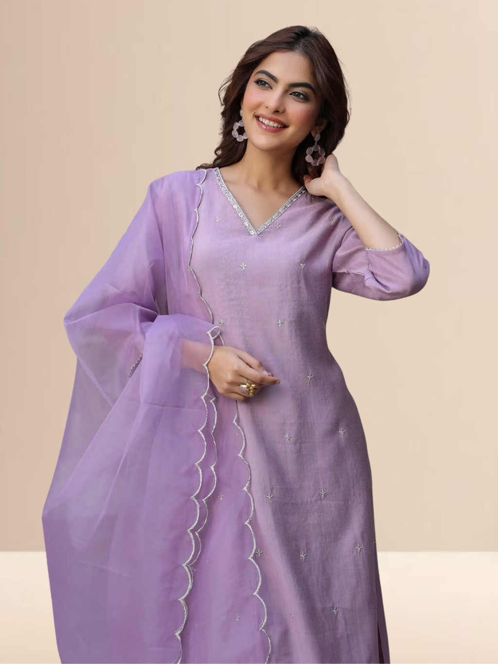Woman wearing a lavender cotton blend kurta set with V-neck embroidery and a sheer scalloped edge dupatta.