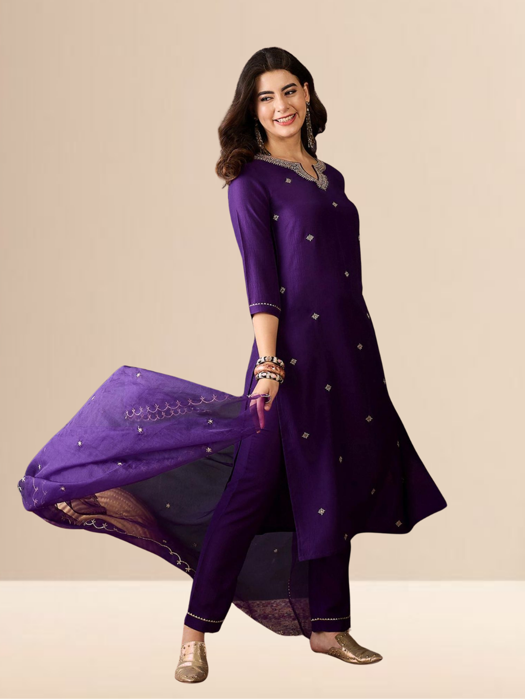 Woman wearing a purple traditional outfit with silver embroidery on a beige background