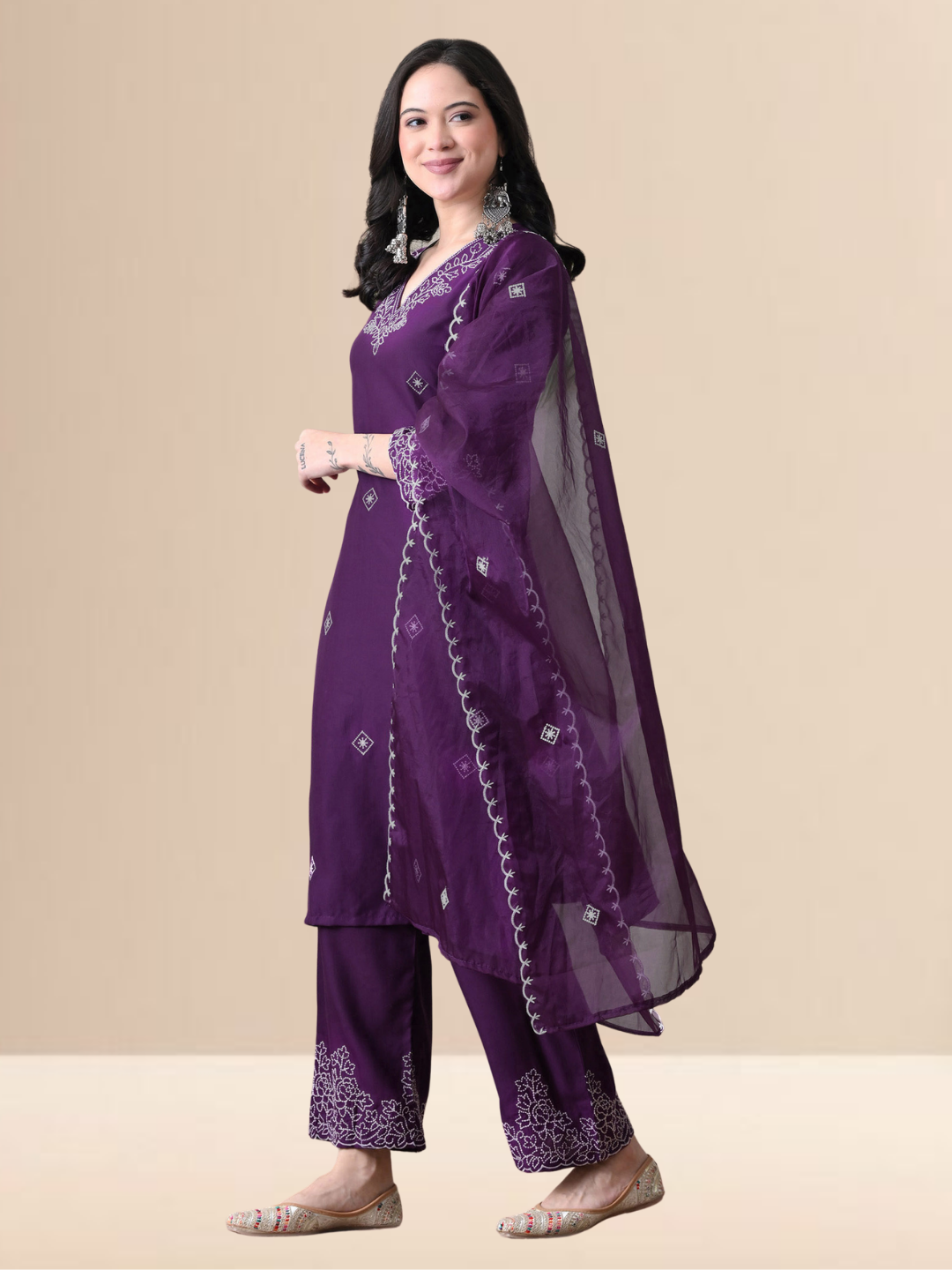 Woman wearing a deep purple cotton blend kurta set with white V-neck embroidery and a sheer scalloped dupatta.
