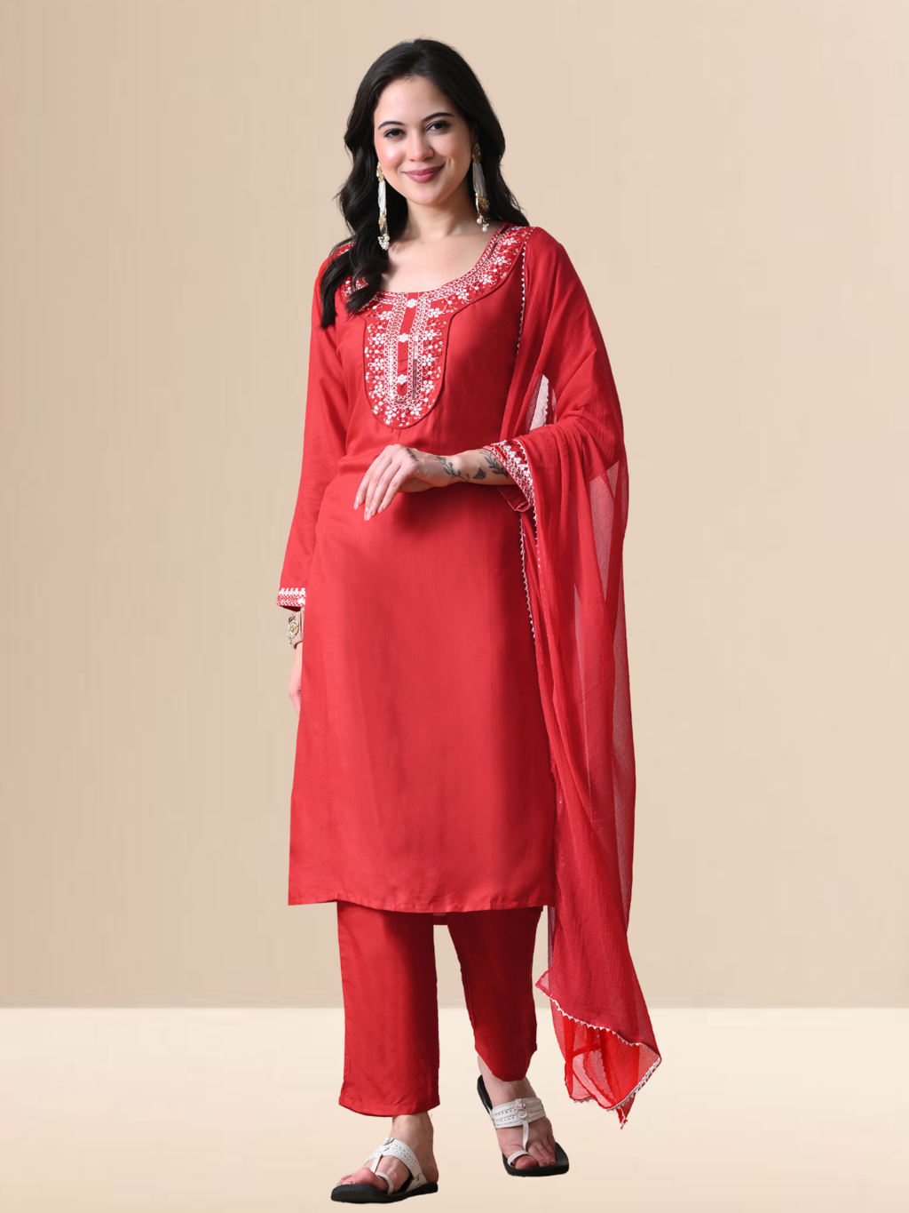 Woman wearing a radiant red blend kurta with white floral embroidery and sequins on the neck, matching red pants, and a sheer red chiffon dupatta.