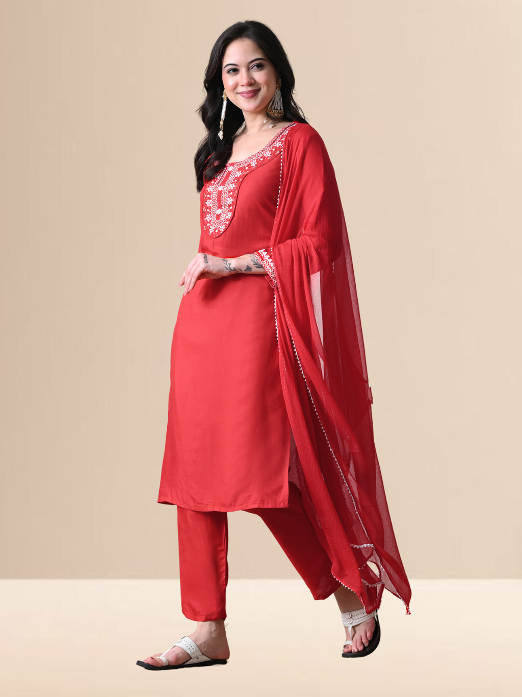 Woman wearing a radiant red blend kurta with white floral embroidery and sequins on the neck, matching red pants, and a sheer red chiffon dupatta.