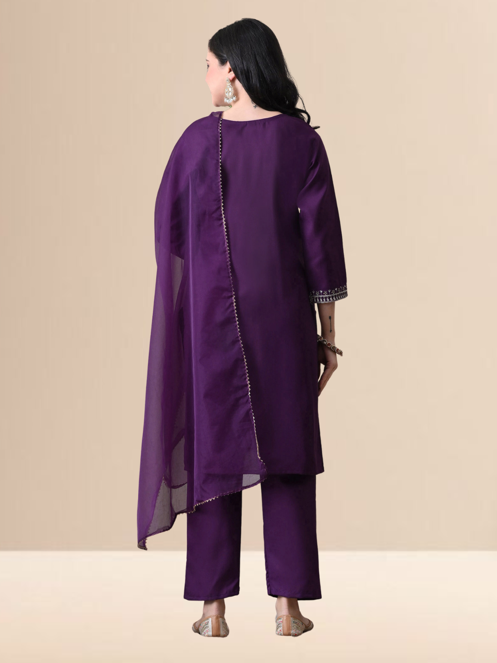 Woman wearing a royal grape purple blend kurta with silver yoke embroidery, matching straight pants, and a purple organza dupatta.