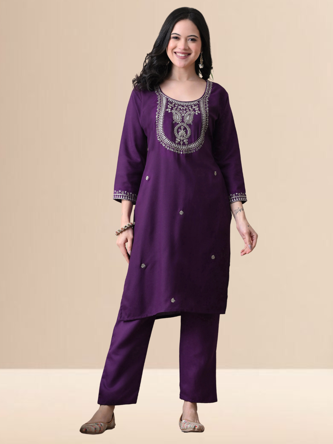 Woman wearing a royal grape purple blend kurta with silver yoke embroidery, matching straight pants, and a purple organza dupatta.