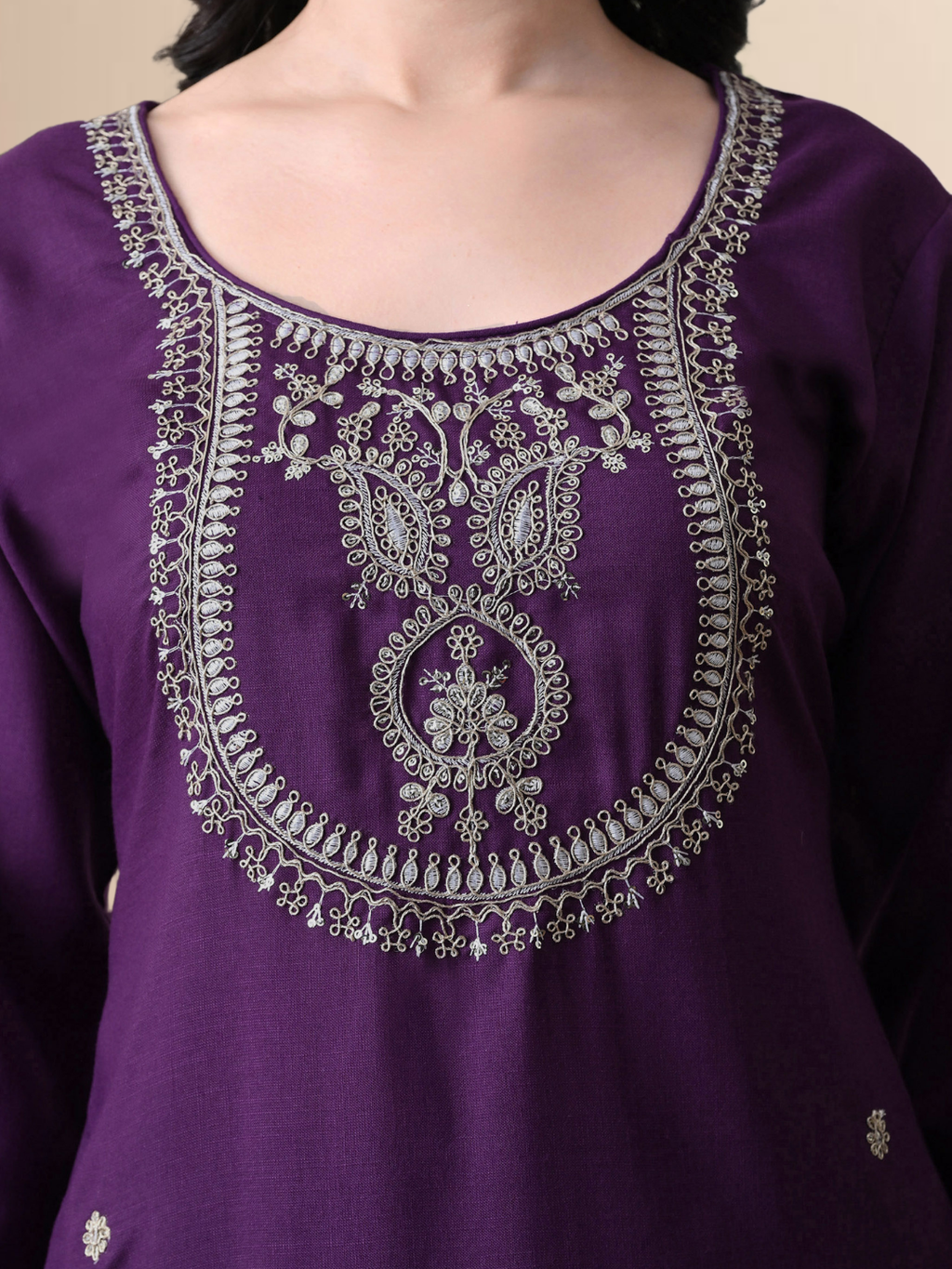 Woman wearing a royal grape purple blend kurta with silver yoke embroidery, matching straight pants, and a purple organza dupatta.