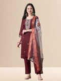 Woman wearing a maroon embroidered cotton kurta set with a floral organza dupatta and matching pants for festive or daily wear.