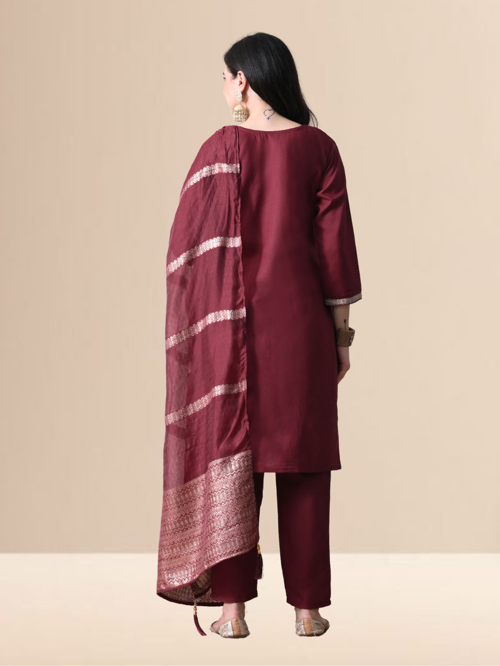 Woman wearing a maroon cotton blend kurta set with intricate silver embroidery on the yoke and a matching striped -style dupatta.