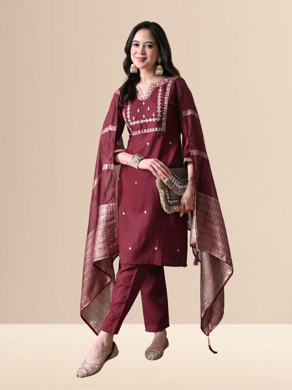 Woman wearing a maroon cotton blend kurta set with intricate silver embroidery on the yoke and a matching striped -style dupatta.