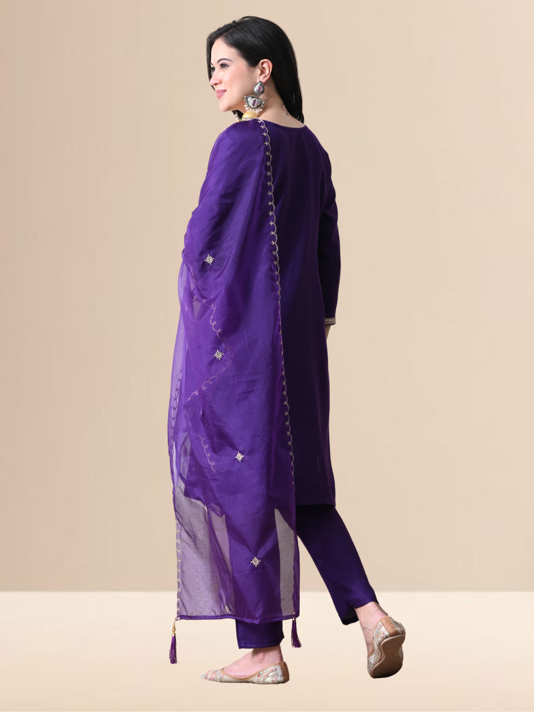 Woman wearing a royal purple cotton blend kurta set with silver embroidery, matching pants, and sheer dupatta.