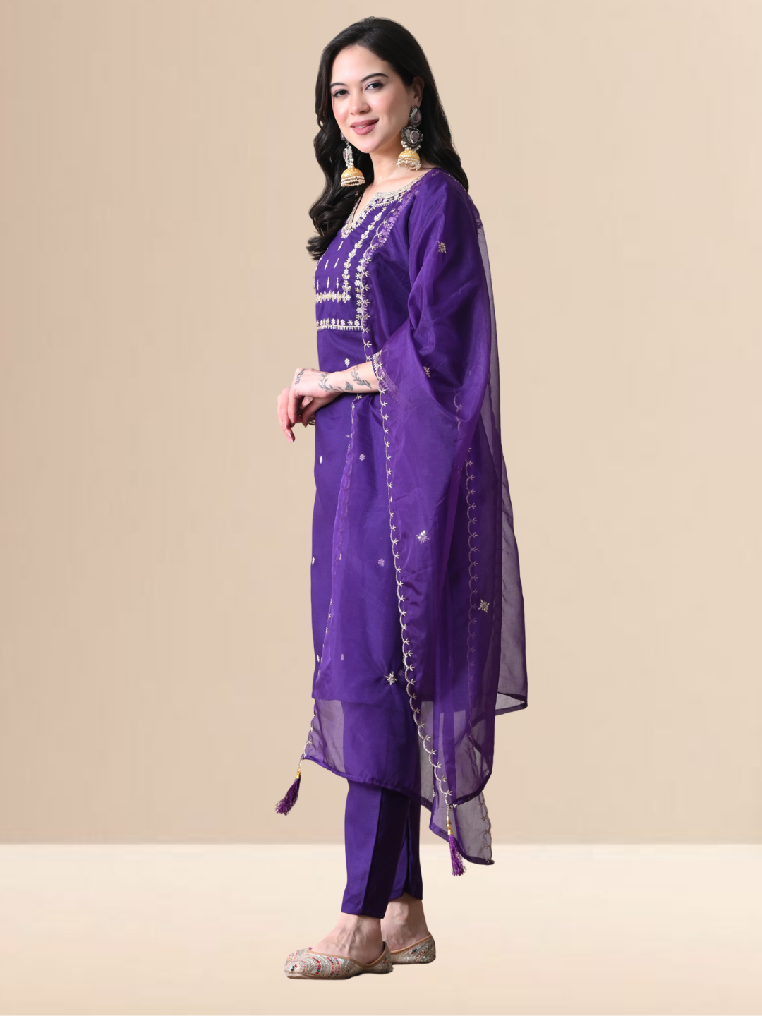Woman wearing a royal purple cotton blend kurta set with silver embroidery, matching pants, and sheer dupatta.