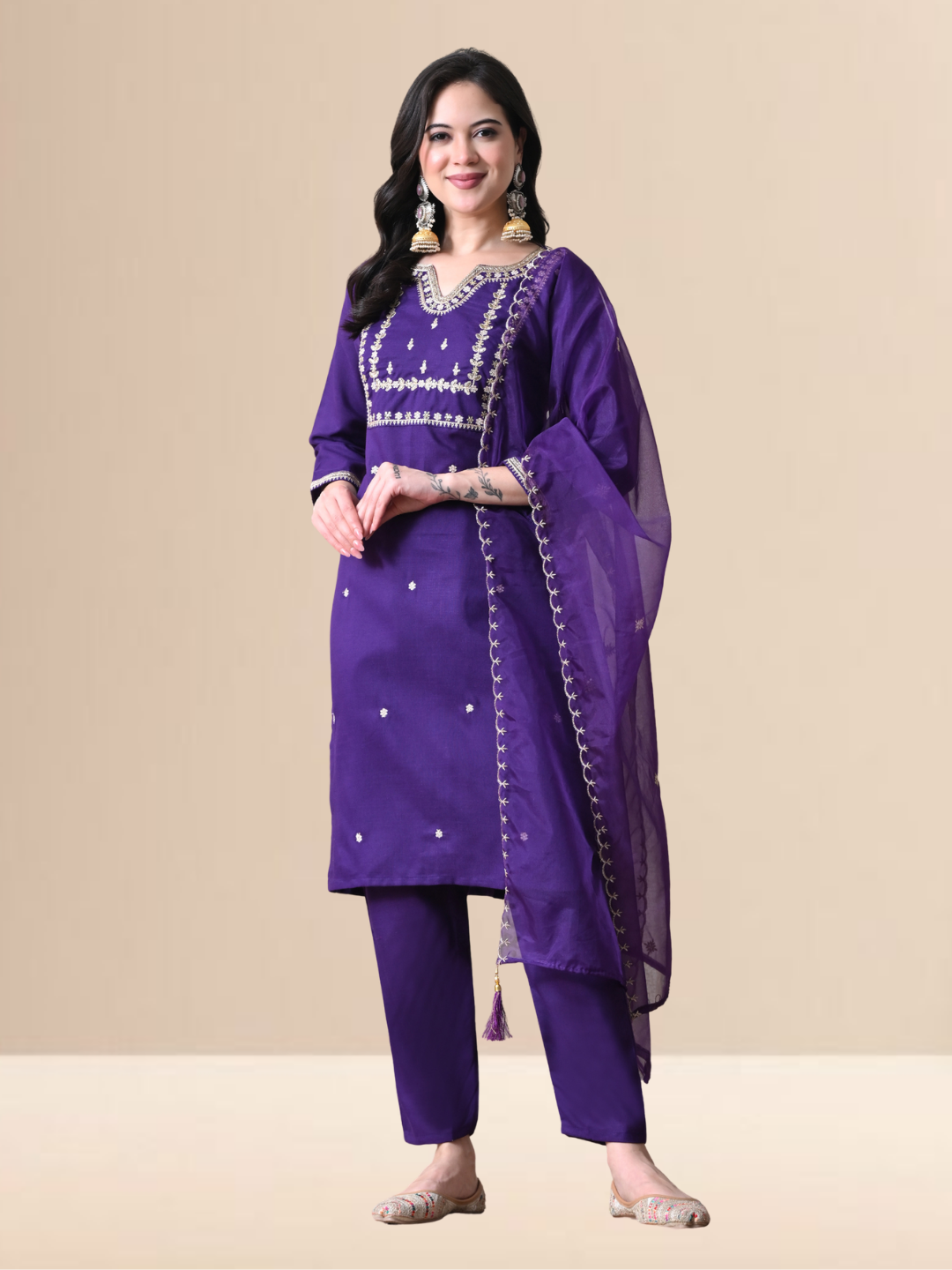 Woman wearing a royal purple cotton blend kurta set with silver embroidery, matching pants, and sheer dupatta.